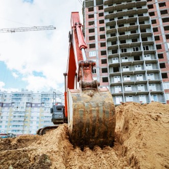 Image de Excavator rakes bucket sand Construction work on site