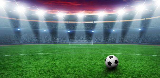 Afbeeldingen van Soccer ball on green stadium
