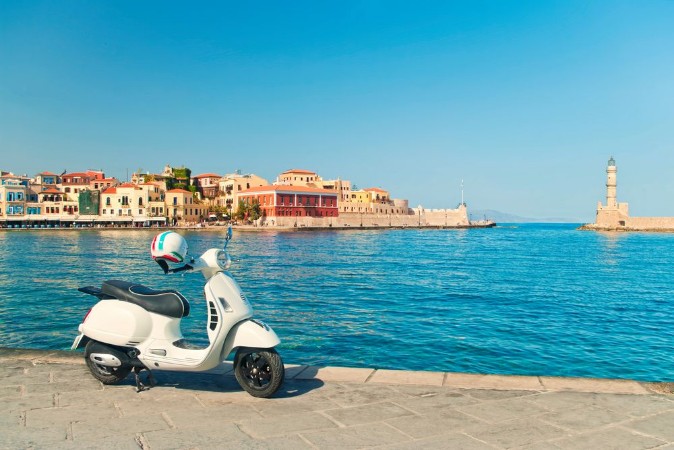 Bild på Travel image of retro scooter in old greek town