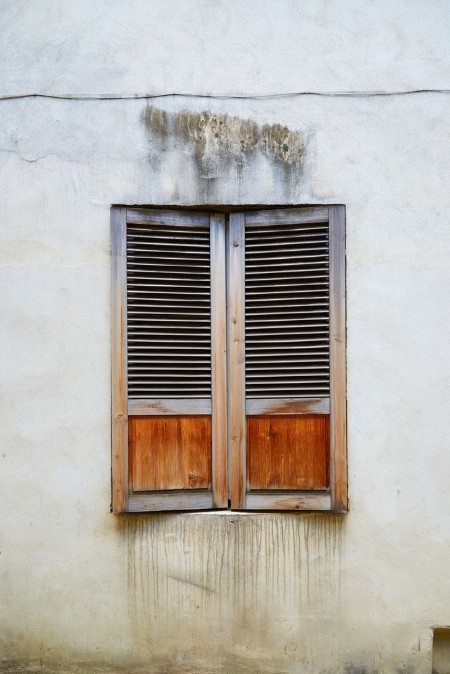 Picture of The old window covered with wooden shutters in the old town in Riga