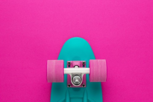 Picture of Plastic mini cruiser board on deep pink with background with copy space