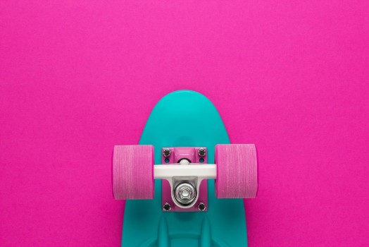 Bild på Plastic mini cruiser board on deep pink with background with copy space