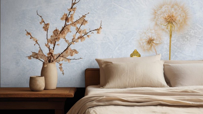 Picture of Buddha pyramid of pebbles burning candle and dandelion flowers as zen background