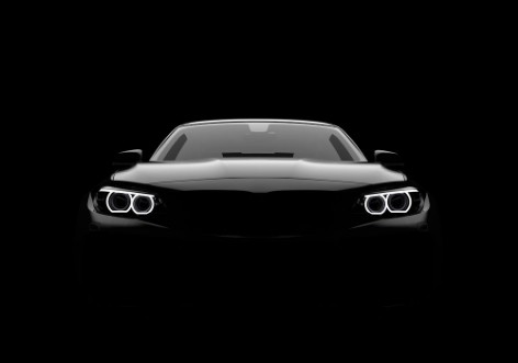 Bild på Front view of a generic and brandless modern car on a black background