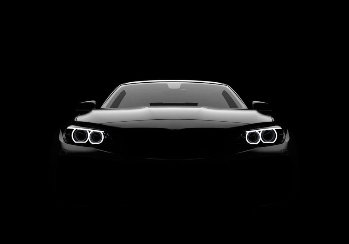 Picture of Front view of a generic and brandless modern car on a black background