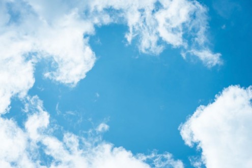 Bild på Cumulus humilis clouds in the blue sky view from below