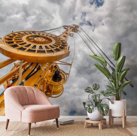 Image de The boom of a drilling machine and a crane against the sky