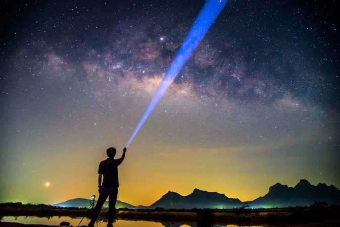 Picture of The man Shining the torch to milky way Milky way with lighting