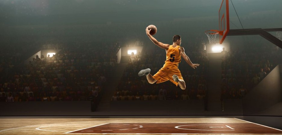 Basketball player on basketball court in action Slam dunk Jump shot photowallpaper Scandiwall