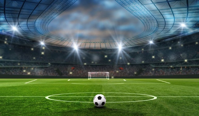 Ball on the green field in soccer stadium ready for game in the midfield photowallpaper Scandiwall