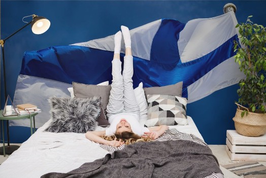 Bild på Finnish national flag on the wind against the blue sky