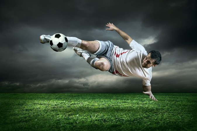 Picture of Football player with ball in action under rain outdoors