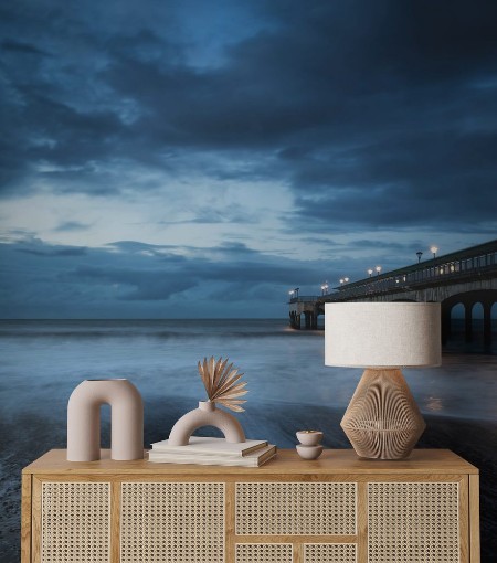 Picture of Twilight dusk landscape of pier stretching out into sea with moo