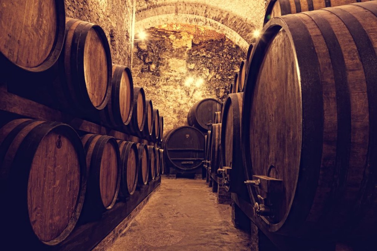 Bild på Wooden barrels with wine in a wine vault Italy