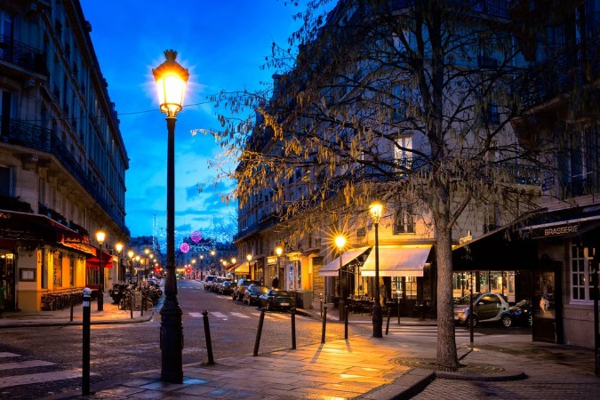 Bild på Paris beautiful street in the evening with lampposts