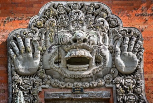 Picture of Carvings depicting demons or gods above the entrance to the temp