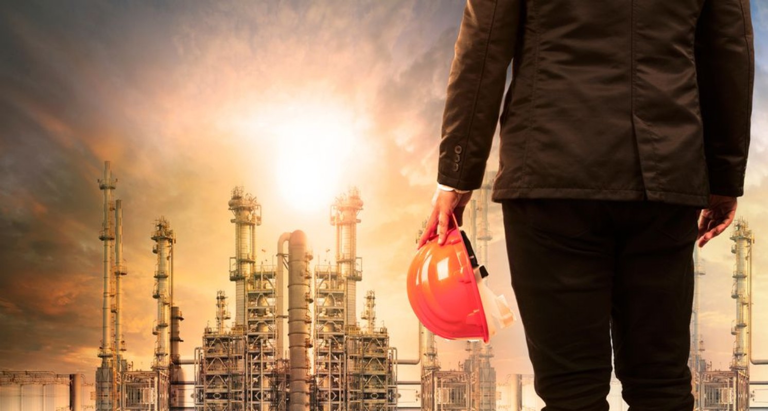 Image de Engineering man with safety helmet standing in industry estate a