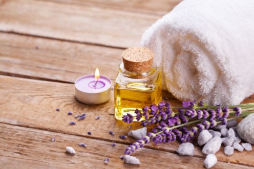 Picture of Spa still life with lavender oil white towel and perfumed candle on natural wood