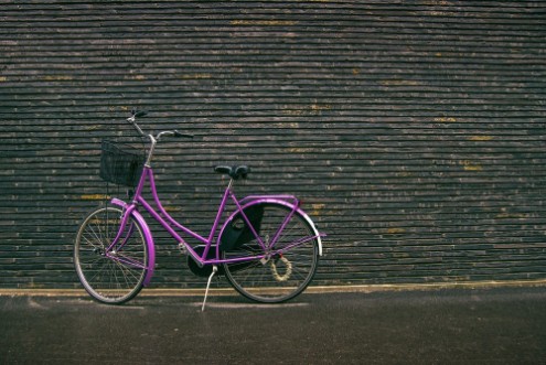 Bild på Classic Vintage Purple Hipster Bicycle on the Street
