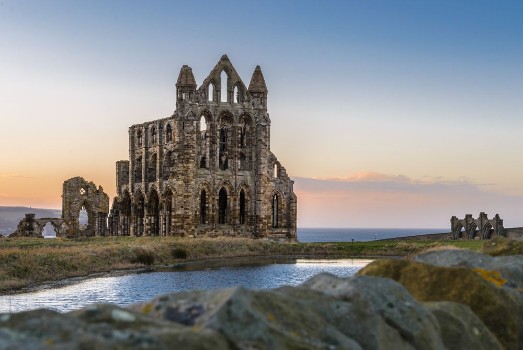 Picture of Stone ruins of Whitby Abbey on the cliffs of Whitby North Yorkshire England at sunset