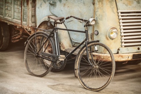 Afbeeldingen van Retro styled image of an ancient bike and truck