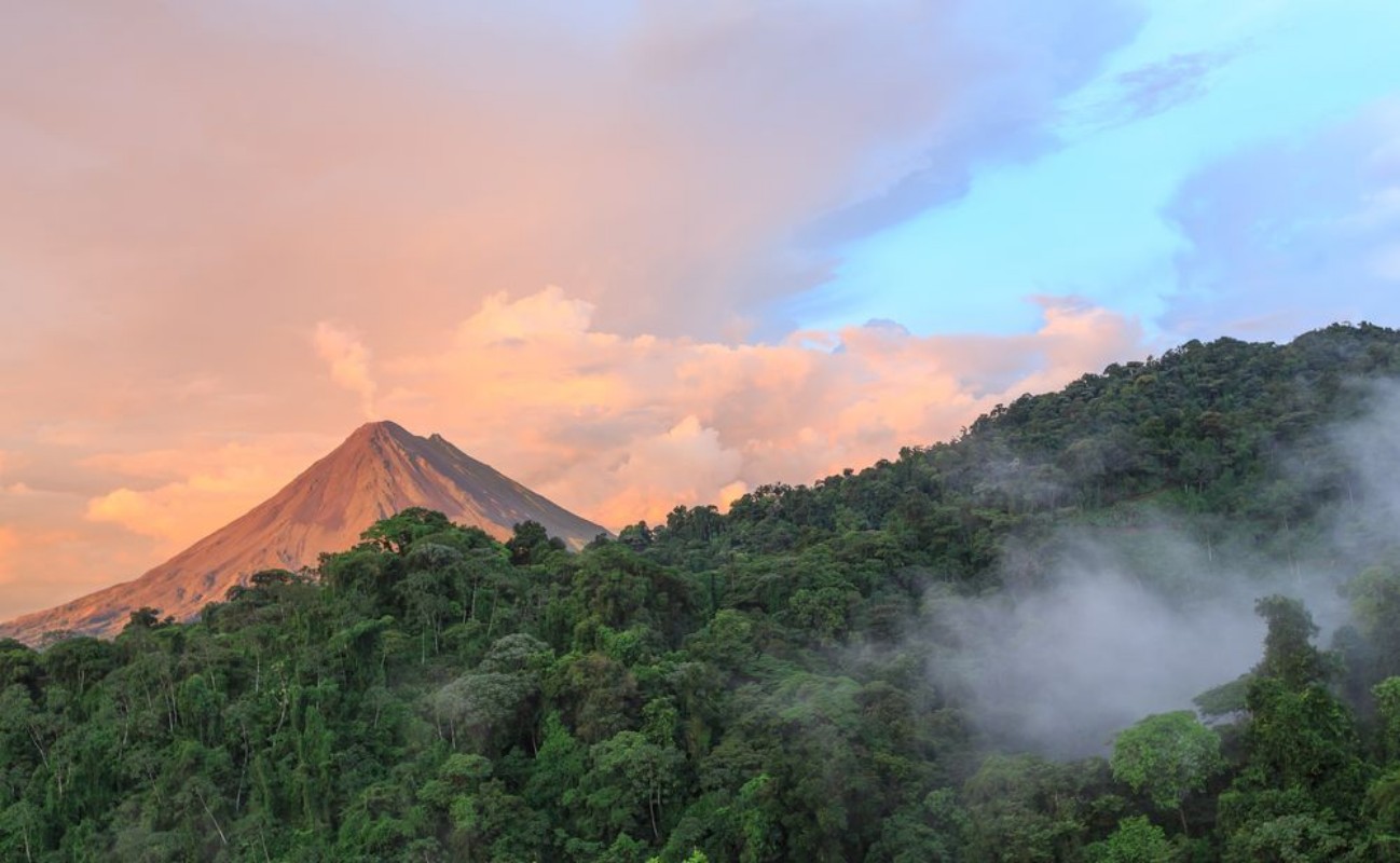 Picture of Sunset by Arenal Volcano in Costa Rica cloud forest clouds rise from the jungle floor