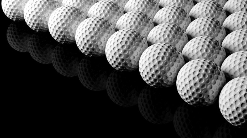 Afbeeldingen van Golf balls isolated on black background with reflection