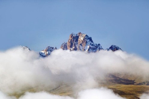 Afbeeldingen van Aerial of Mount Kenya Africa with snow and white puffy clouds in January the second highest mountain at 17058 feet or 5199 Meters