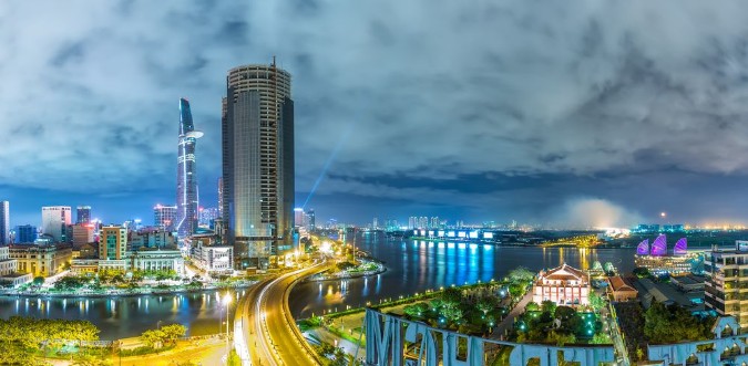 Afbeeldingen van Ho Chi Minh City Vietnam - September 2nd 2015 architectural city at night with lights on skyscrapers confluence three rivers present developed full life in Ho Chi Minh City Vietnam